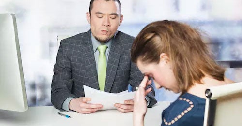 Upset women sitting opposite a snide man in a suit