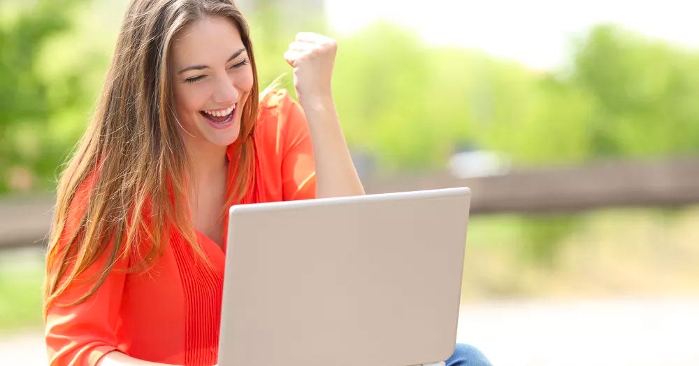 Excited woman pumping her fist in the air