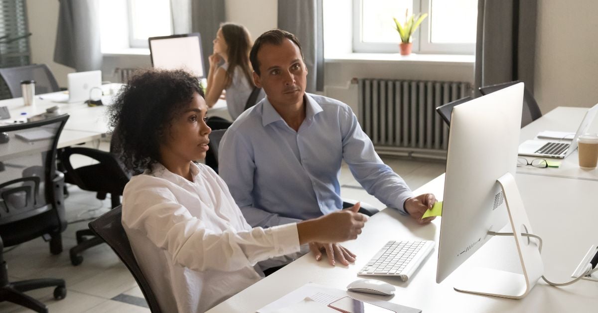 Two people working at a computer