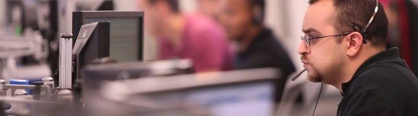 Profile view of a man looking at a computer monitor