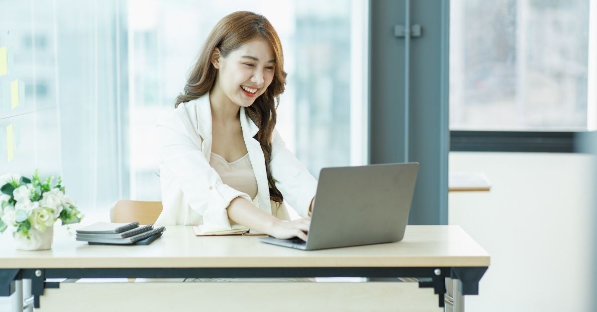 Woman reading from a laptop