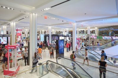 A busy mall with people walking in multiple directions