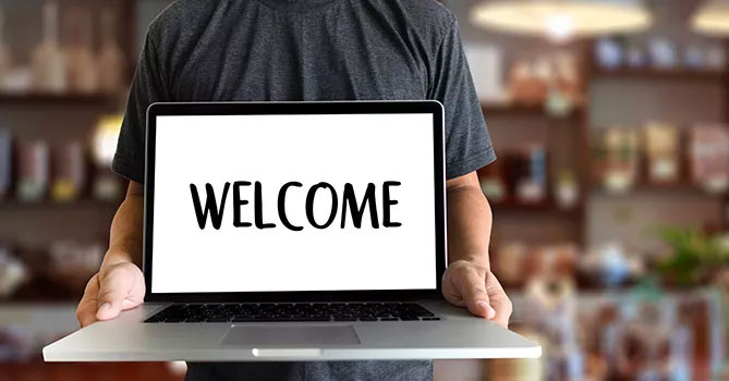 The word "Welcome" typed onto a computer monitor