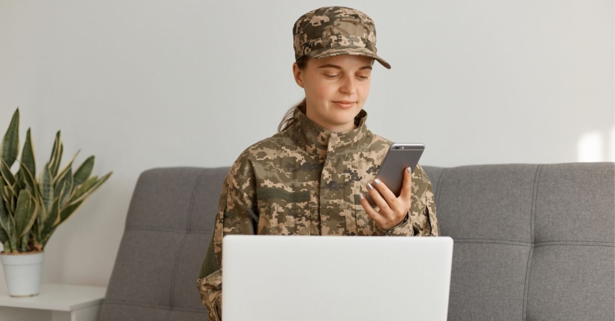 Military person reading a smartphone