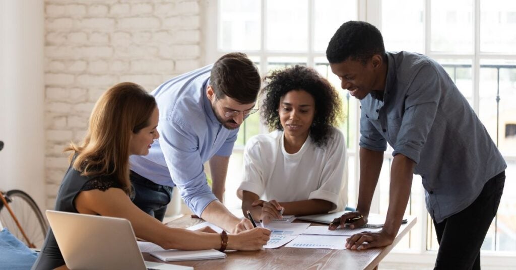 inclusive-workplace- people gathered around a conference table