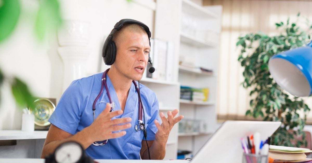 Medical professional talking into a computer screen