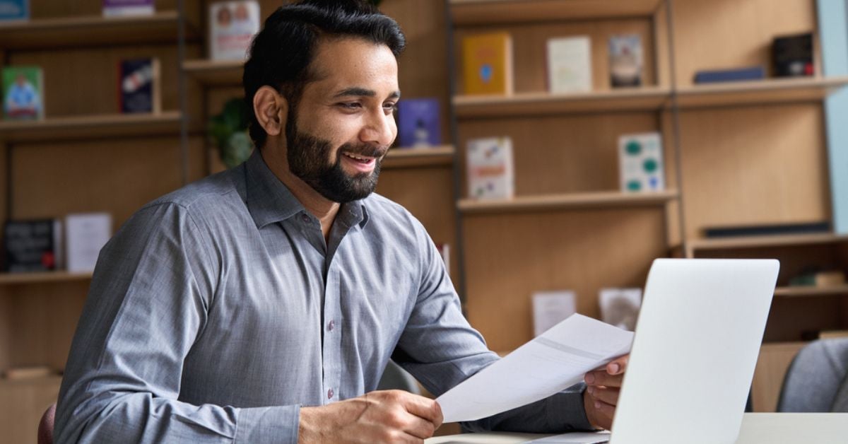 Smiling man holding a document