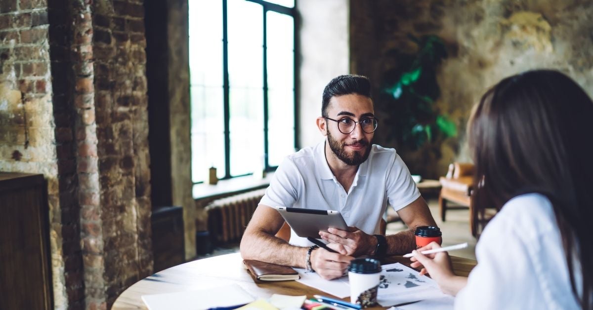 Two people at a table talking