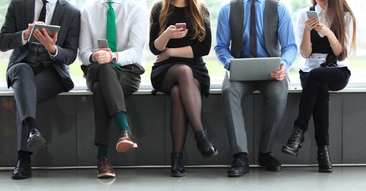 People sitting in a row on a bench