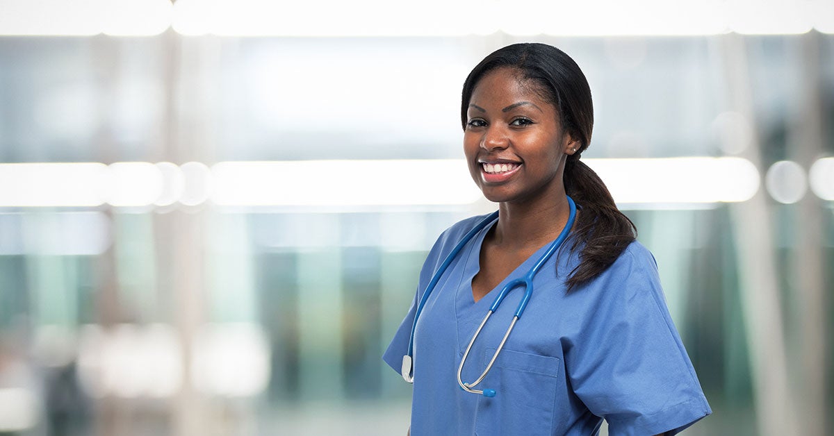 Female healthcare worker standing in a haliway