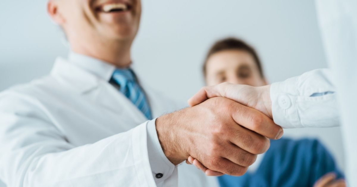 Two medical professionals shaking hands