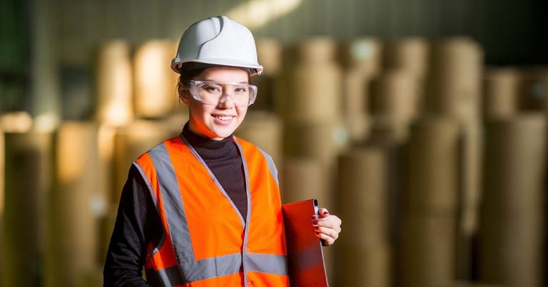 Woman in a hardhat and orange safety vest