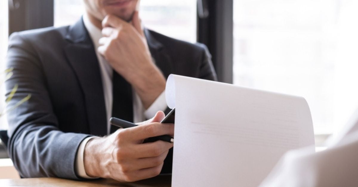 Man reading a report he holds in his hands