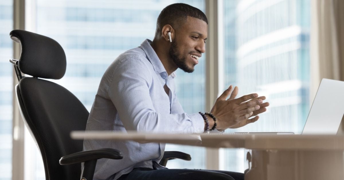 Smiling man talking to someone on a video call