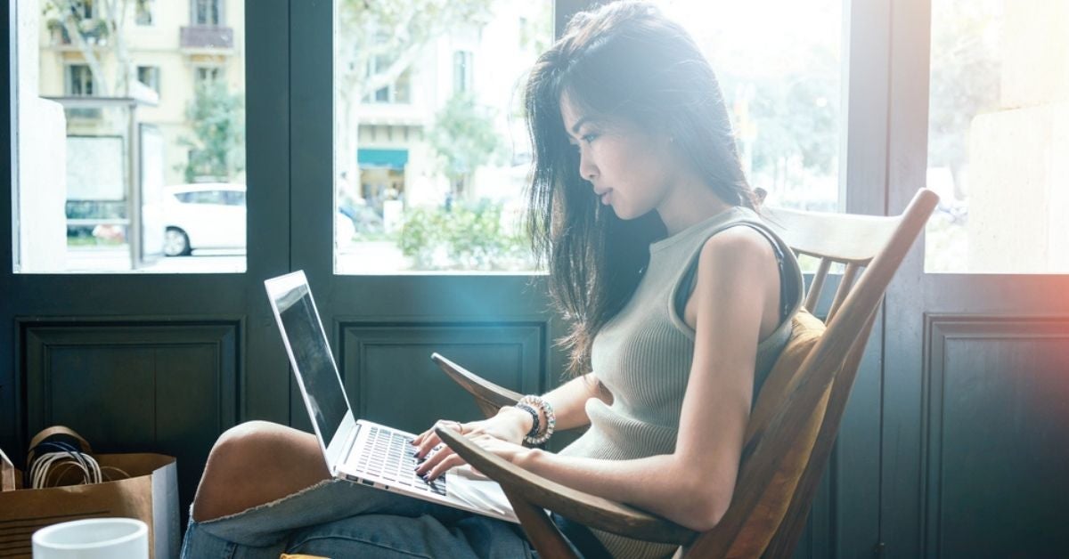 Woman typing on a laptop