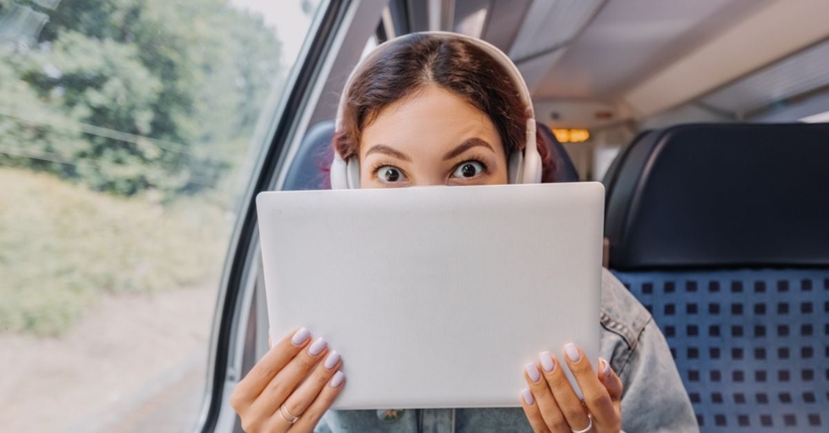 Woman holding a document in front of her face