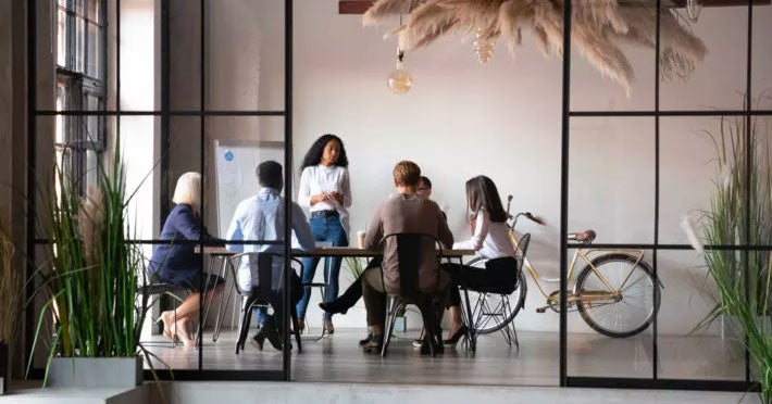 Group of people sitting at a conference table in a modern office