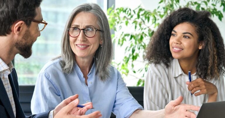 Two women listening to a person speaking