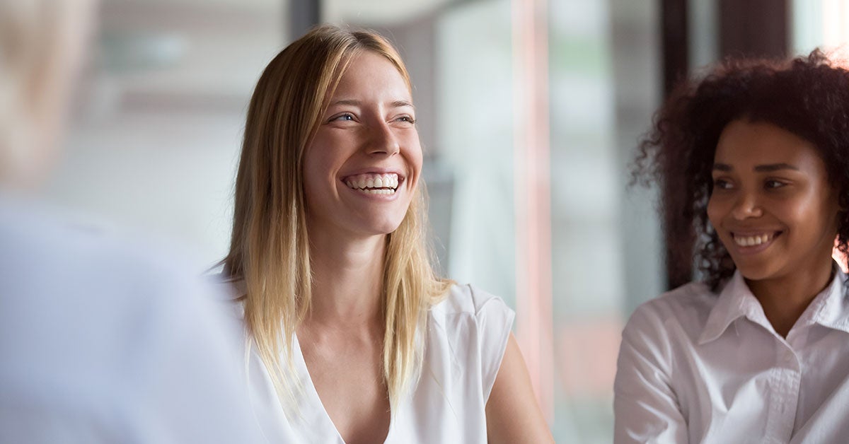 Two woman laughing in an office