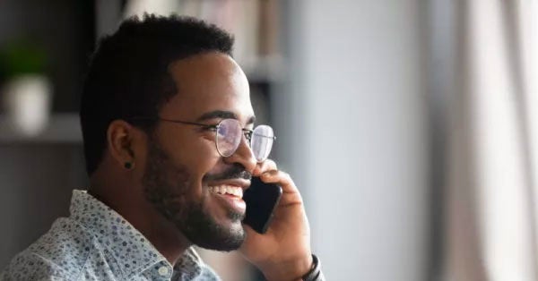 Smiling man talking on a smartphone