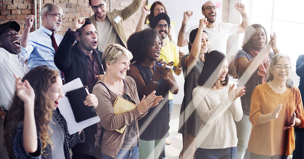 Large group of people clapping and cheering