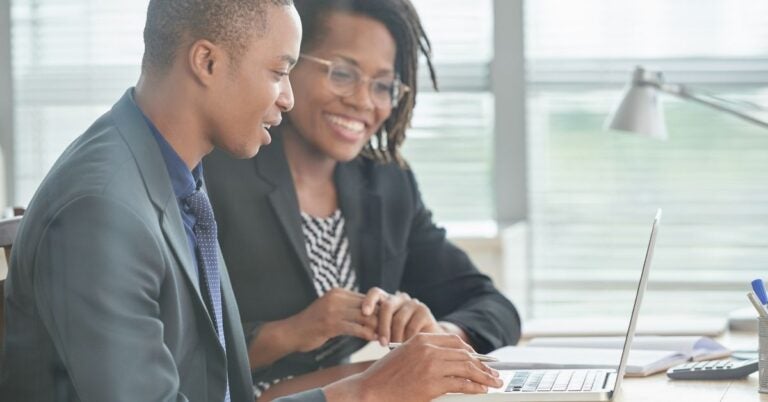 Two people reading a report