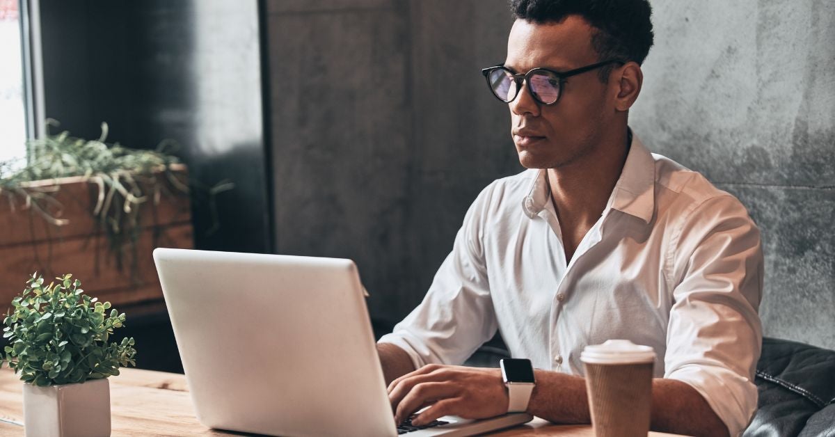 Man typing on a laptop keyboard