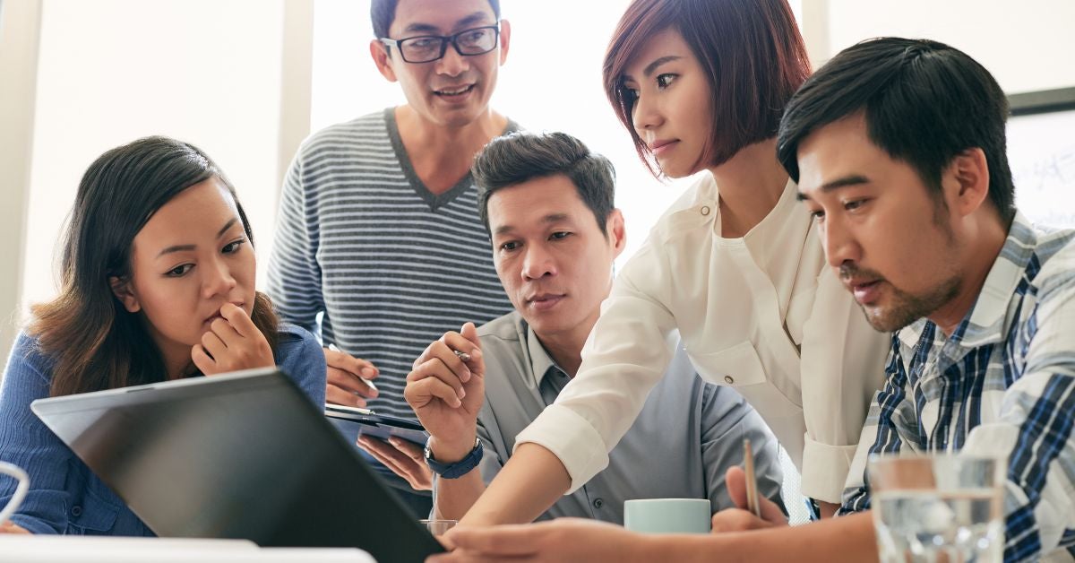 Group of people looking at a tablet