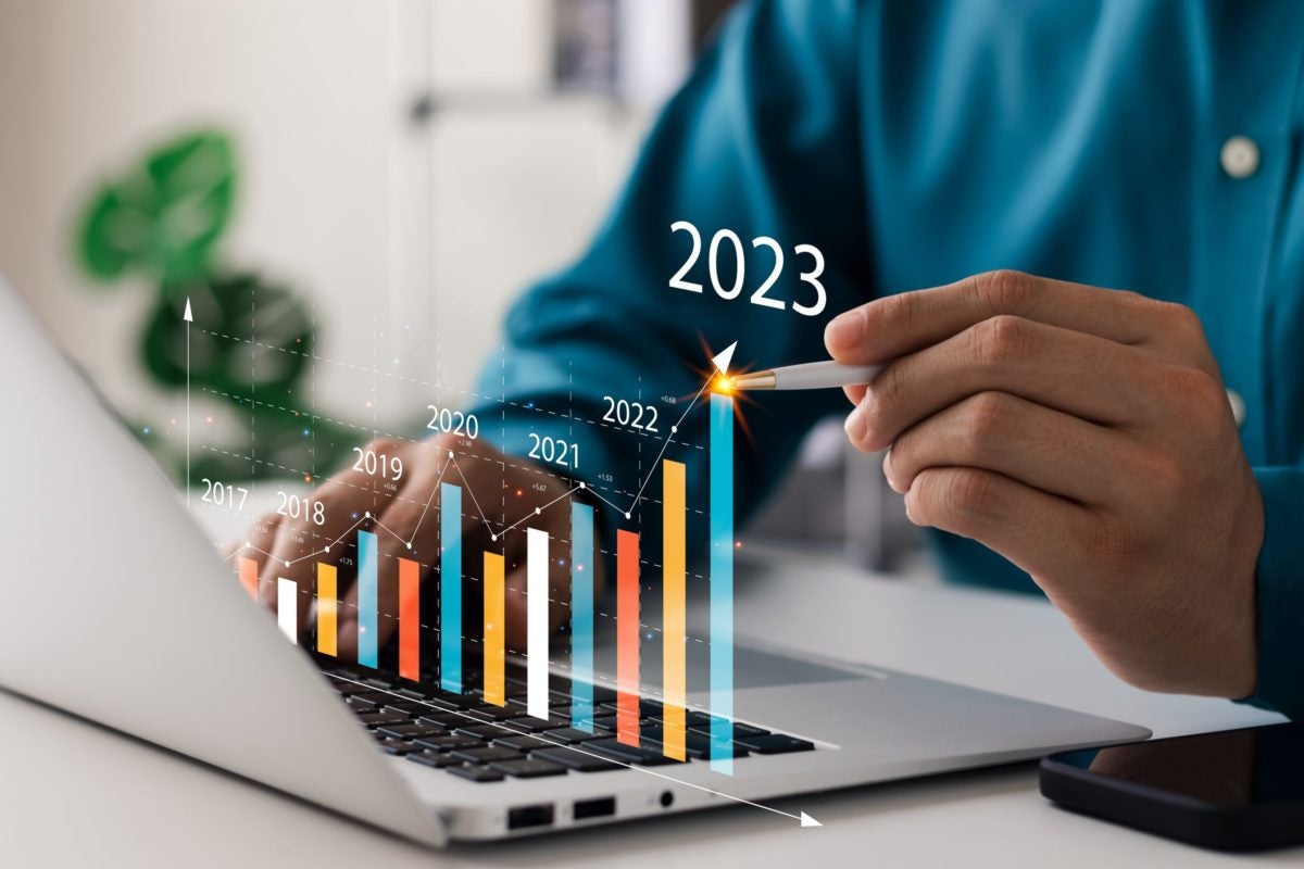 person at laptop with 3D graph