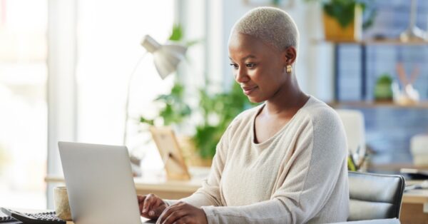 Woman looking thoughtfully at her computer