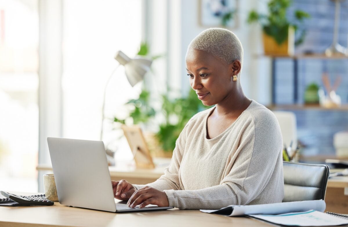 Woman looking thoughtfully at her computer