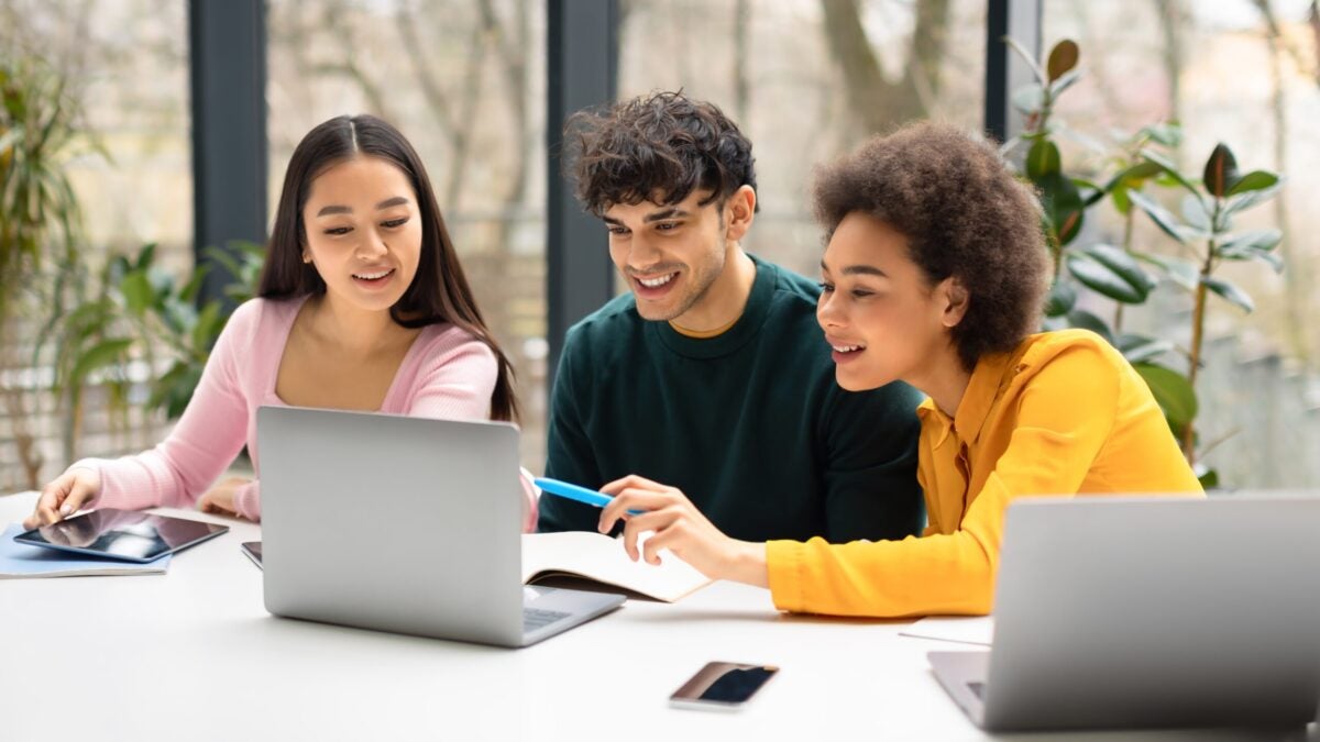 Happy recruiters reading information on a computer