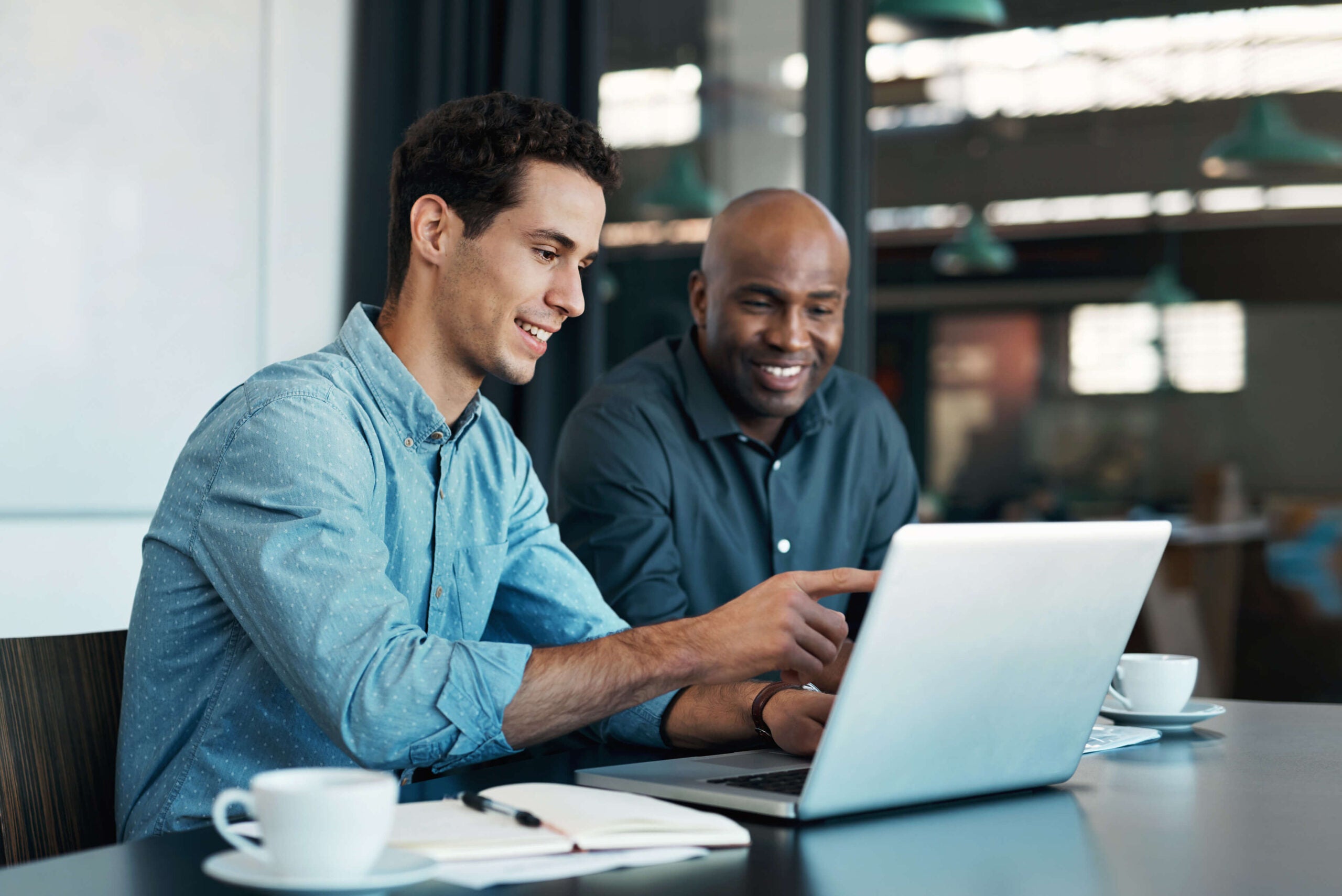 business colleagues discuss work on laptop