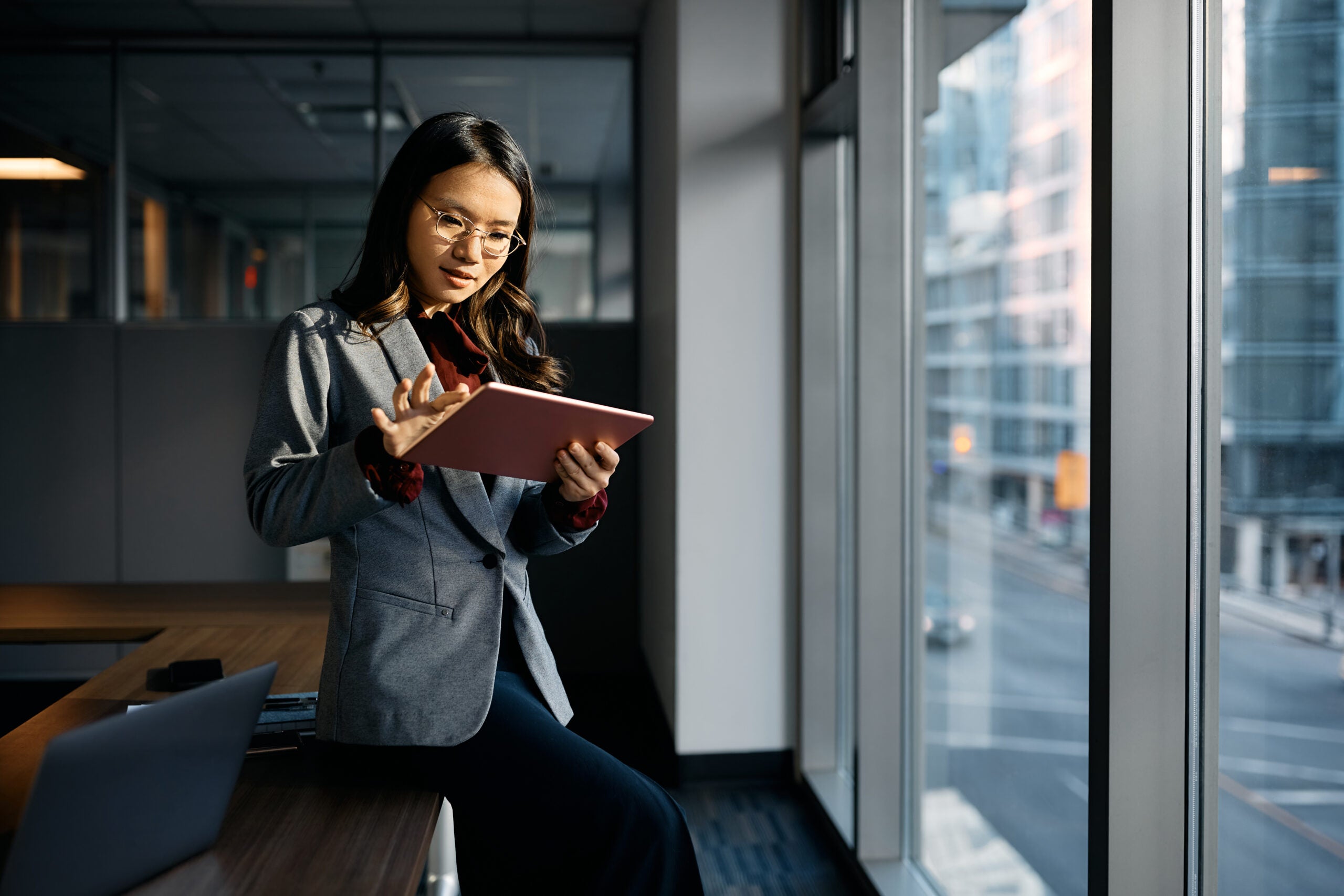 Business woman looking at a digital tablet in an office