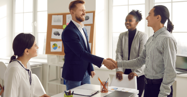 hiring manager shakes job candidates hand