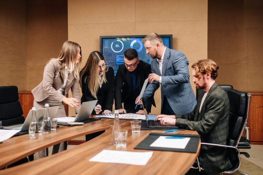 Group of professionals reviewing data in a boardroom